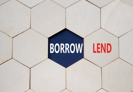 Lend or Borrow symbol. Concept word Lend or Borrow on wooden comb puzzle. Beautiful deep blue background. Business and Lend or Borrow concept. Copy spaceの写真素材