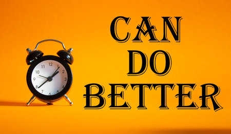 Can Do better symbol. Beautiful orange background with alarm clock. Business and Can Do better concept. Copy space.の写真素材