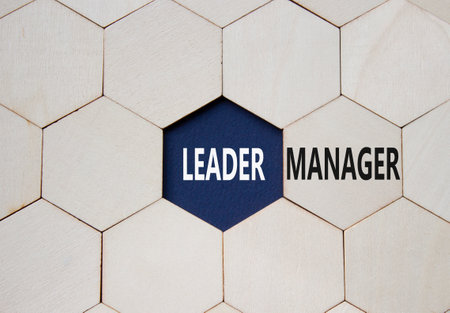 Leader or Manager symbol. Concept word Leader or Manager on wooden comb puzzle. Beautiful deep blue background. Business and Leader or Manager concept. Copy spaceの写真素材