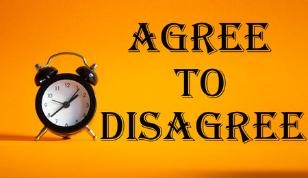 Agree to Disagree symbol. Beautiful orange background with alarm clock. Business and Agree to Disagree concept. Copy space.の写真素材