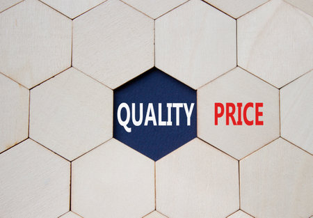 Price or Quality symbol. Concept word Price or Quality on wooden comb puzzle. Beautiful deep blue background. Business and Price or Quality concept. Copy spaceの写真素材