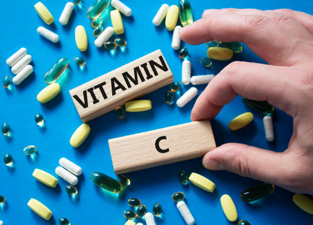 Vitamin C symbol. Concept word Vitamin C on wooden blocks. Beautiful blue background with pills. Medicine and Vitamin C concept. Copy spaceの写真素材