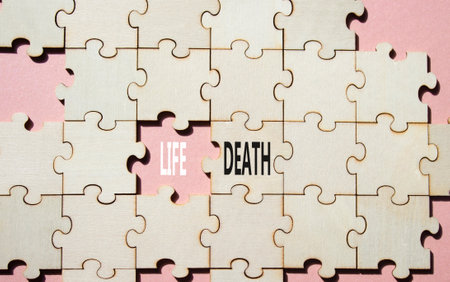 Life or Death symbol. Concept word Life or Death on wooden puzzle. Beautiful pink background. Business and Life or Death concept. Copy spaceの写真素材