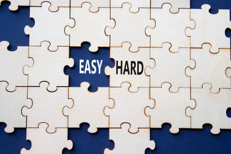 Easy or Hard symbol. Concept word Easy or Hard on wooden puzzle. Beautiful deep blue background. Business and Easy or Hard concept. Copy spaceの写真素材