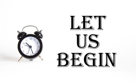 Let us begin symbol. Concept word Let us begin on Beautiful white background with alarm clock. Business and Let us begin concept. Copy spaceの写真素材