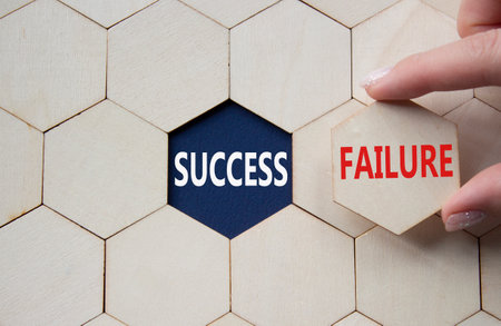 Success or Failure symbol. Concept word Success or Failure on wooden comb puzzle. Businessman hand. Beautiful deep blue background. Business and Success or Failure concept. Copy spaceの写真素材
