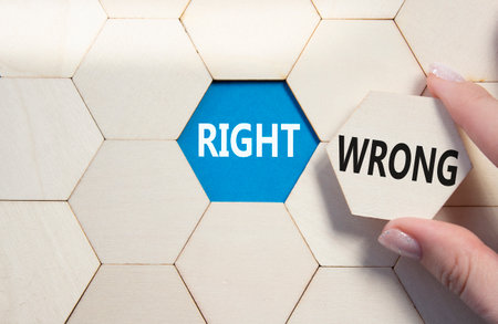 Risk or Reward symbol. Concept word Risk or Reward on wooden comb puzzle. Businessman hand. Beautiful blue background. Business and Risk or Reward concept. Copy spaceの写真素材