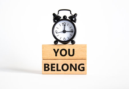You belong symbol. Concept words You belong on wooden blocks. Beautiful white background with alarm clock. Business and You belong concept. Copy space.の写真素材