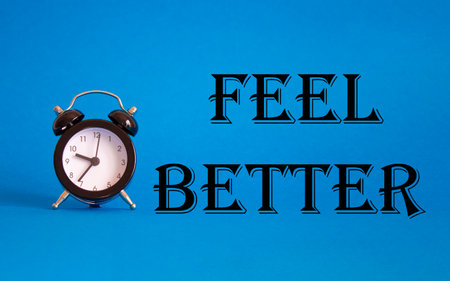 Feel better symbol. Beautiful blue background with alarm clock. Business and Feel better concept. Copy space.の写真素材
