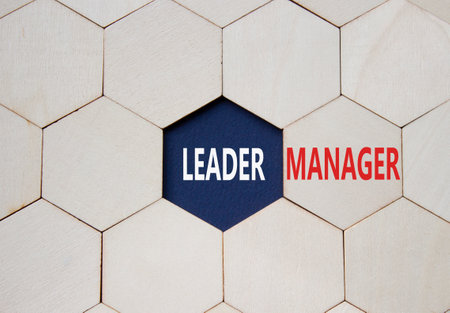 Leader or Manager symbol. Concept word Leader or Manager on wooden comb puzzle. Beautiful deep blue background. Business and Leader or Manager concept. Copy spaceの写真素材
