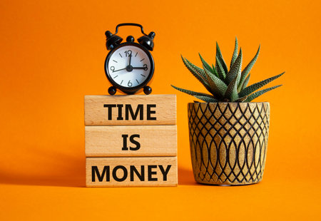 Time is Money symbol. Concept words Time is Money on wooden blocks. Beautiful orange background with...