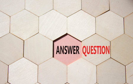 Answer or Question symbol. Concept word Answer or Question on wooden comb puzzle. Beautiful pink...