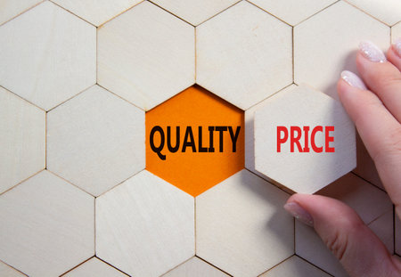 Price or Quality symbol. Concept word Price or Quality on wooden comb puzzle. Businessman hand....
