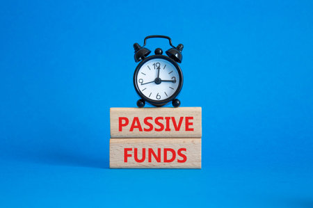 Passive Funds symbol. Concept words Passive Funds on wooden blocks. Beautiful blue background with...