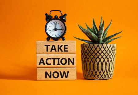 Take action now symbol. Wooden blocks with words Take action now. Beautiful orange background with...