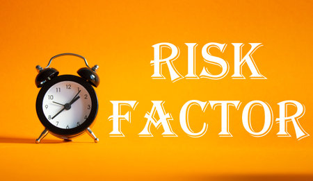 Risk Factor symbol. Concept words Risk Factor on Beautiful orange background with alarm clock....