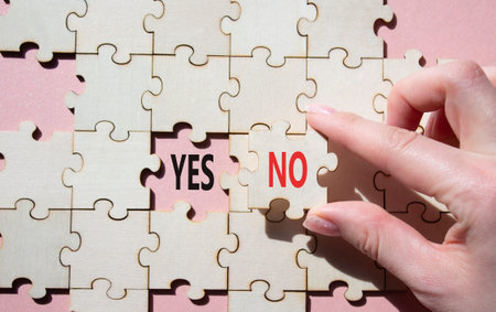Yes or No symbol. Concept word Yes or No on wooden puzzle. Businessman hand. Beautiful pink...