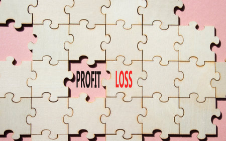 Profit or Loss symbol. Concept word Profit or Loss on wooden puzzle. Beautiful pink background. Business and Profit or Loss concept. Copy spaceの写真素材