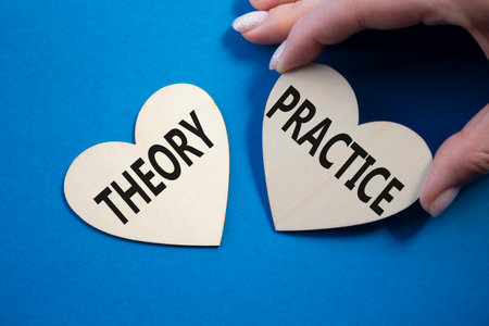Theory or practice symbol. Concept word Theory or Practice on wooden hearts. Businessman hand. Beautiful blue background. Business and Theory or Practice concept. Copy spaceの写真素材