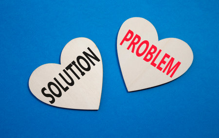 Solution vs Problem symbol. Concept word Solution vs Problem on wooden hearts. Beautiful blue background. Business and Solution vs Problem concept. Copy spaceの写真素材