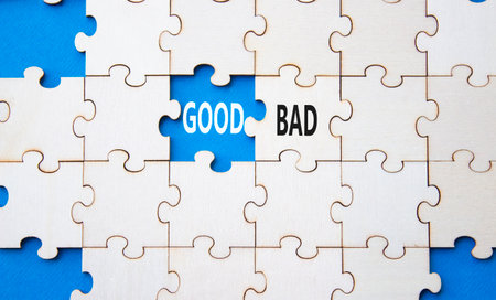 Good or Bad symbol. Concept word Good or Bad on wooden puzzle. Beautiful blue background. Business and Good or Bad concept. Copy spaceの写真素材