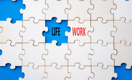 Life or Work symbol. Concept word Life or Work on wooden puzzle. Beautiful blue background. Business and Life or Work concept. Copy spaceの写真素材