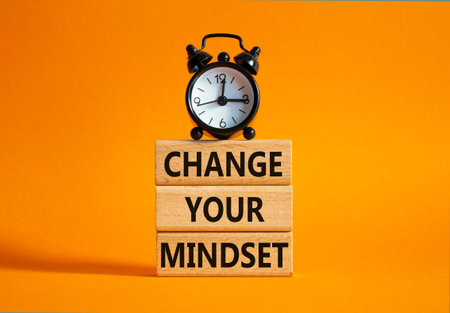 Change your mindset symbol. Concept words Change your mindset on wooden blocks with alarm clock....
