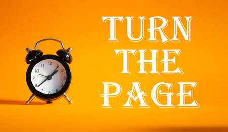 Turn the Page symbol. Concept words Turn the Page on Beautiful orange background with alarm clock....
