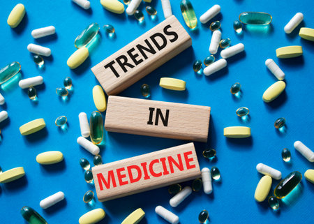 Medicine symbol. Concept words Trends in Medicine on wooden blocks. Beautiful blue background with...
