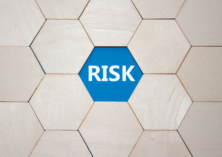 Risk symbol. Concept word Risk on wooden comb puzzle. Beautiful blue background. Business and Risk concept. Copy space.の写真素材