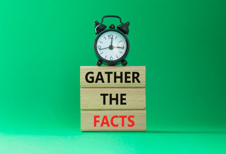 Gather the facts symbol. Wooden blocks with words Gather the facts. Beautiful green background with alarm clock. Business and Gather the facts concept. Copy space.の写真素材