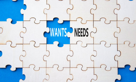 Wants and Needs symbol. Concept word Wants and Needs on wooden blocks. Beautiful blue background. Business and Wants and Needs concept. Copy spaceの写真素材