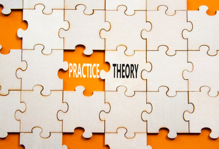 Theory or practice symbol. Concept word Theory or Practice on wooden puzzle. Beautiful orange background. Business and Theory or Practice concept. Copy spaceの写真素材