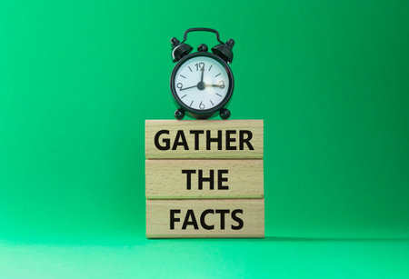 Gather the facts symbol. Wooden blocks with words Gather the facts. Beautiful green background with...