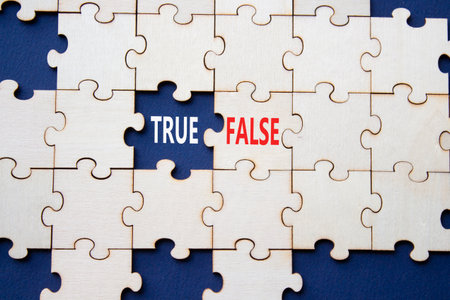 True or False symbol. Concept word True or False on wooden puzzle. Beautiful deep blue background. Business and True or False concept. Copy spaceの写真素材