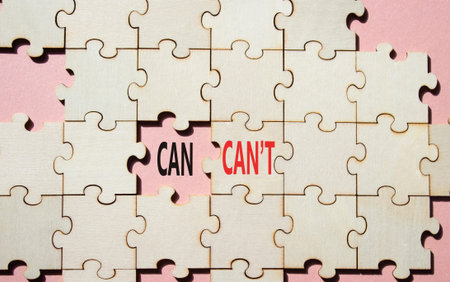 Can or Cant symbol. Concept word Can or Cant on wooden puzzle. Beautiful pink background. Business...
