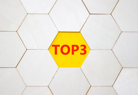 Top 3 symbol. Concept word Top 3 on wooden comb puzzle. Beautiful yellow background. Business and Top 3 concept. Copy space.の写真素材