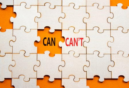 Can or Cant symbol. Concept word Can or Cant on wooden puzzle. Beautiful orange background. Business and Can or Cant concept. Copy spaceの写真素材