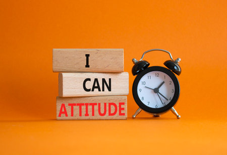 I Can Attitude symbol. Wooden blocks with words I Can Attitude. Beautiful orange background with alarm clock. Business and I Can Attitude concept. Copy space.の写真素材