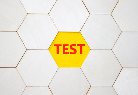 Test symbol. Concept word Test on wooden comb puzzle. Beautiful yellow background. Business and Test concept. Copy space.の写真素材