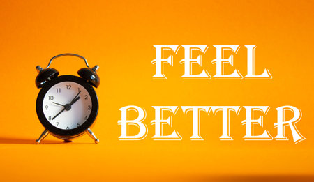 Feel better symbol. Beautiful orange background with alarm clock. Business and Feel better concept....