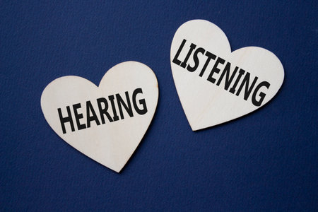 Growth and Stability symbol. Concept word Growth and Stability on wooden hearts. Beautiful deep blue background. Business and Growth and Stability concept. Copy spaceの写真素材