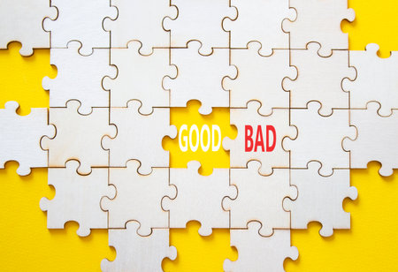 Good or Bad symbol. Concept word Good or Bad on wooden puzzle. Beautiful yellow background. Business and Good or Bad concept. Copy spaceの写真素材