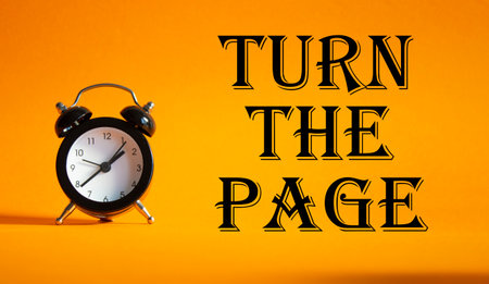 Turn the Page symbol. Concept words Turn the Page on Beautiful orange background with alarm clock. Business and Turn the Page concept. Copy space.の写真素材
