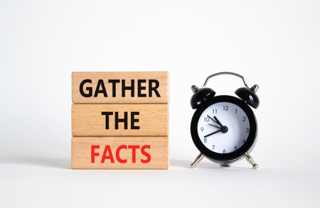 Gather the facts symbol. Wooden blocks with words Gather the facts. Beautiful white background with alarm clock. Business and Gather the facts concept. Copy space.の写真素材
