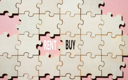 Rent or Buy symbol. Concept word Rent or Buy on wooden puzzle. Beautiful pink background. Business and Rent or Buy concept. Copy spaceの写真素材