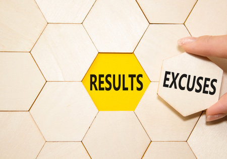 Results or Excuses symbol. Concept word Results or Excuses on wooden comb puzzle. Businessman hand....
