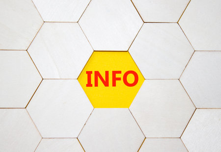 Info symbol. Concept word Info on wooden comb puzzle. Beautiful yellow background. Business and Info...