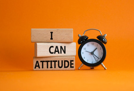I Can Attitude symbol. Wooden blocks with words I Can Attitude. Beautiful orange background with alarm clock. Business and I Can Attitude concept. Copy space.の写真素材