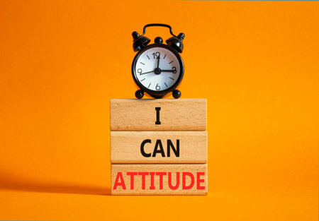 I Can Attitude symbol. Wooden blocks with words I Can Attitude. Beautiful orange background with alarm clock. Business and I Can Attitude concept. Copy space.の写真素材